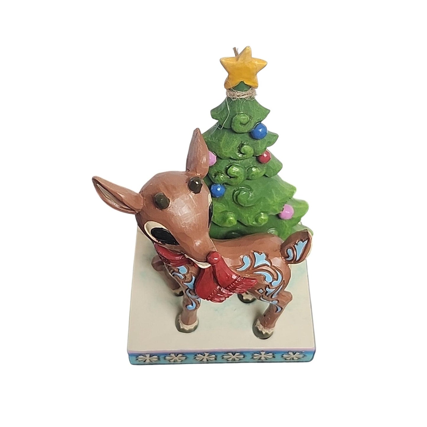 Decorative figurine of a reindeer with a Christmas tree on a white background