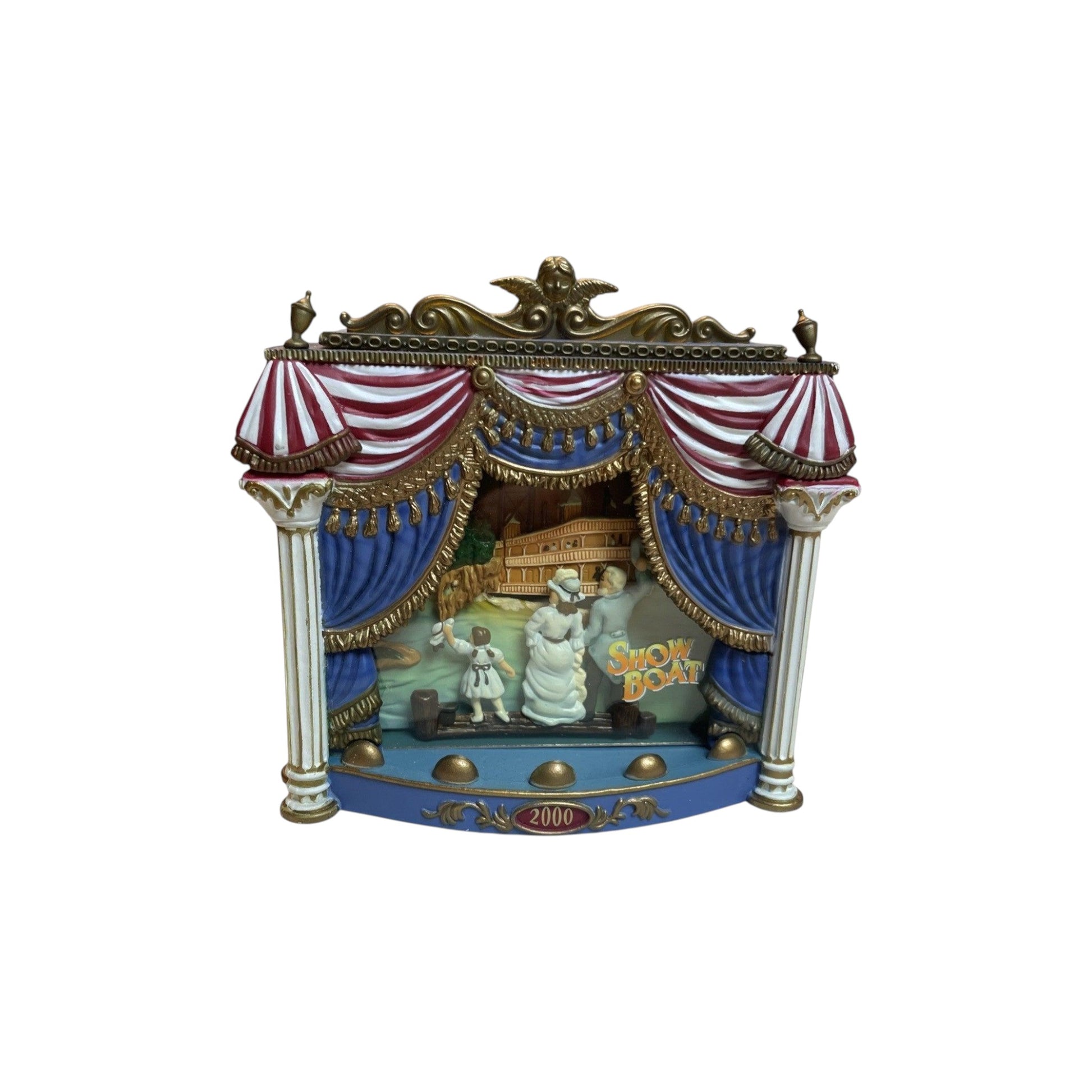 Decorative model of a stage with curtains and 'Show Boat' text on a white background