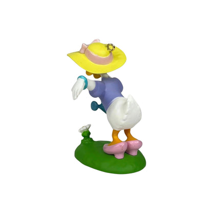Animated character figurine with a yellow hat and purple outfit on a white background