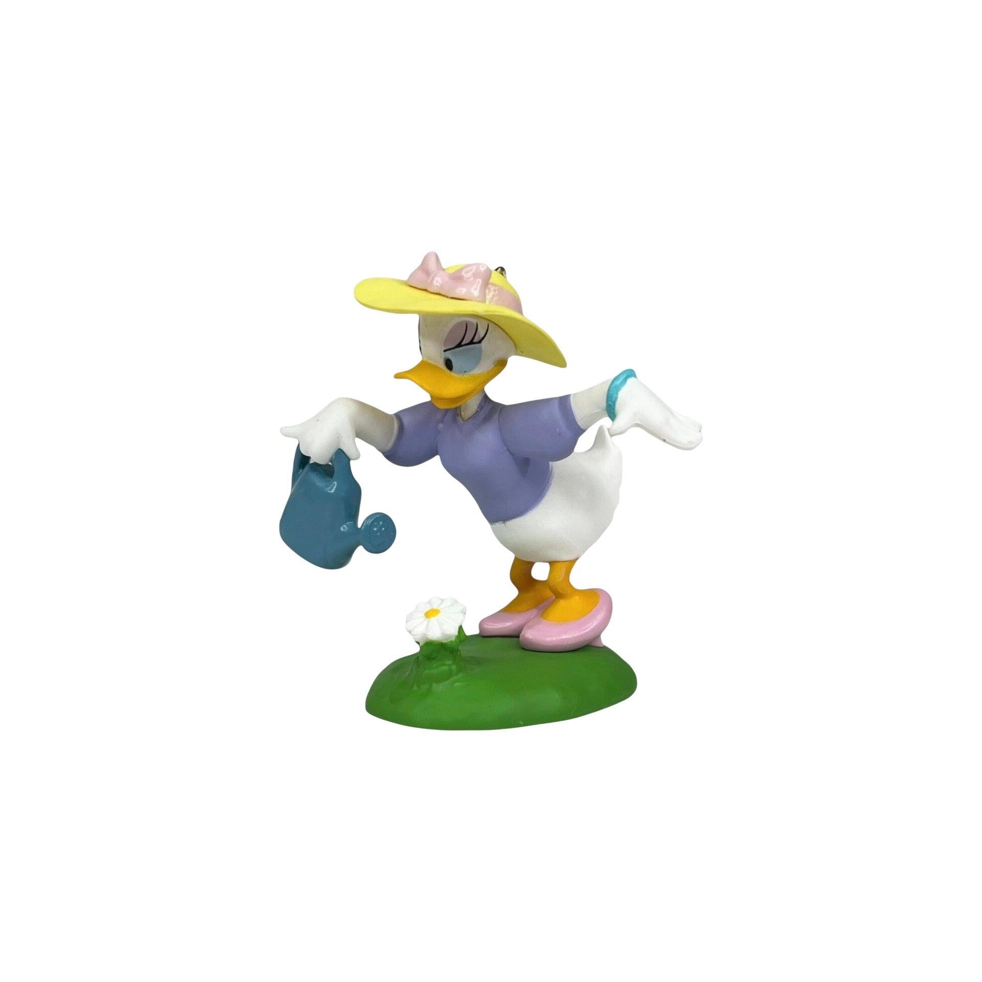 Animated character figure of a duck with a hat and watering can on a white background