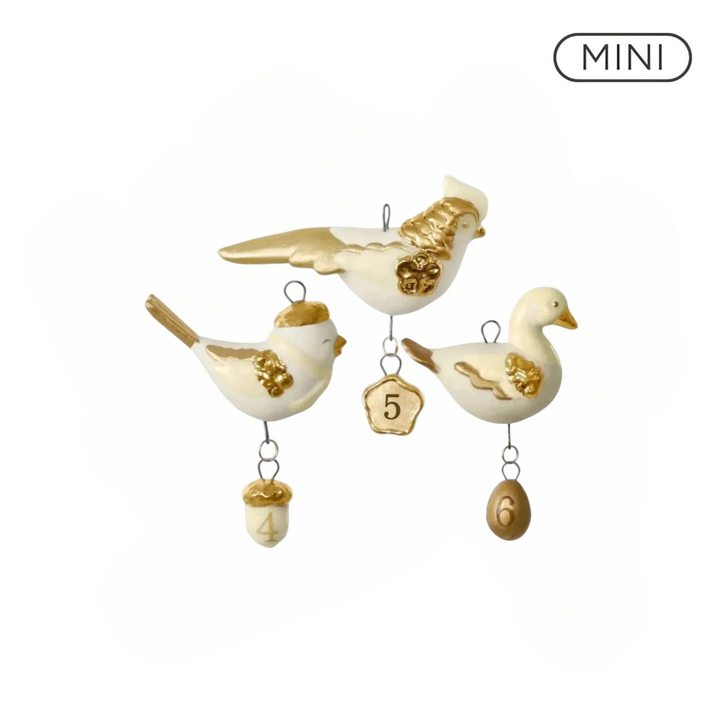 Decorative bird ornaments with gold accents on a white background