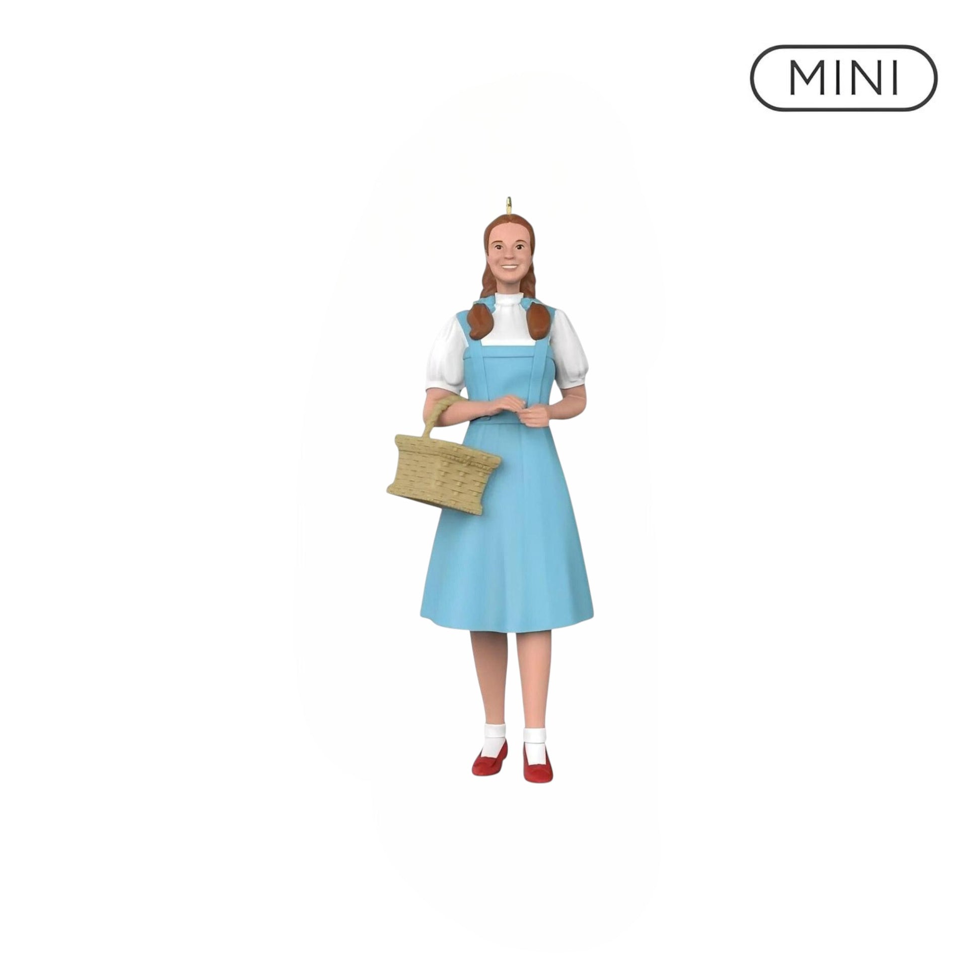 Miniature figure of a character in a blue dress holding a basket on a white background