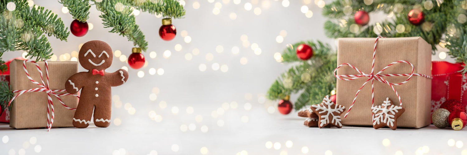 Christmas-themed scene with gingerbread man, gift boxes, and Christmas trees on a white background.