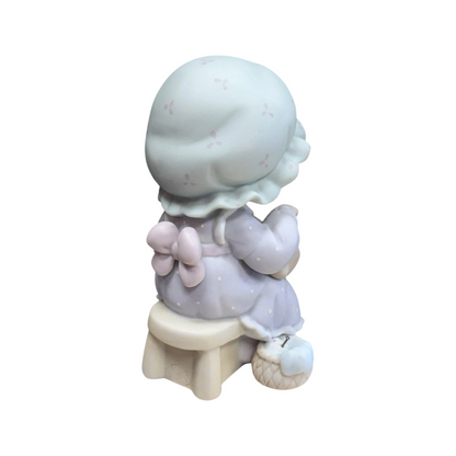 Adorable girl sews patch onto beloved teddy bear