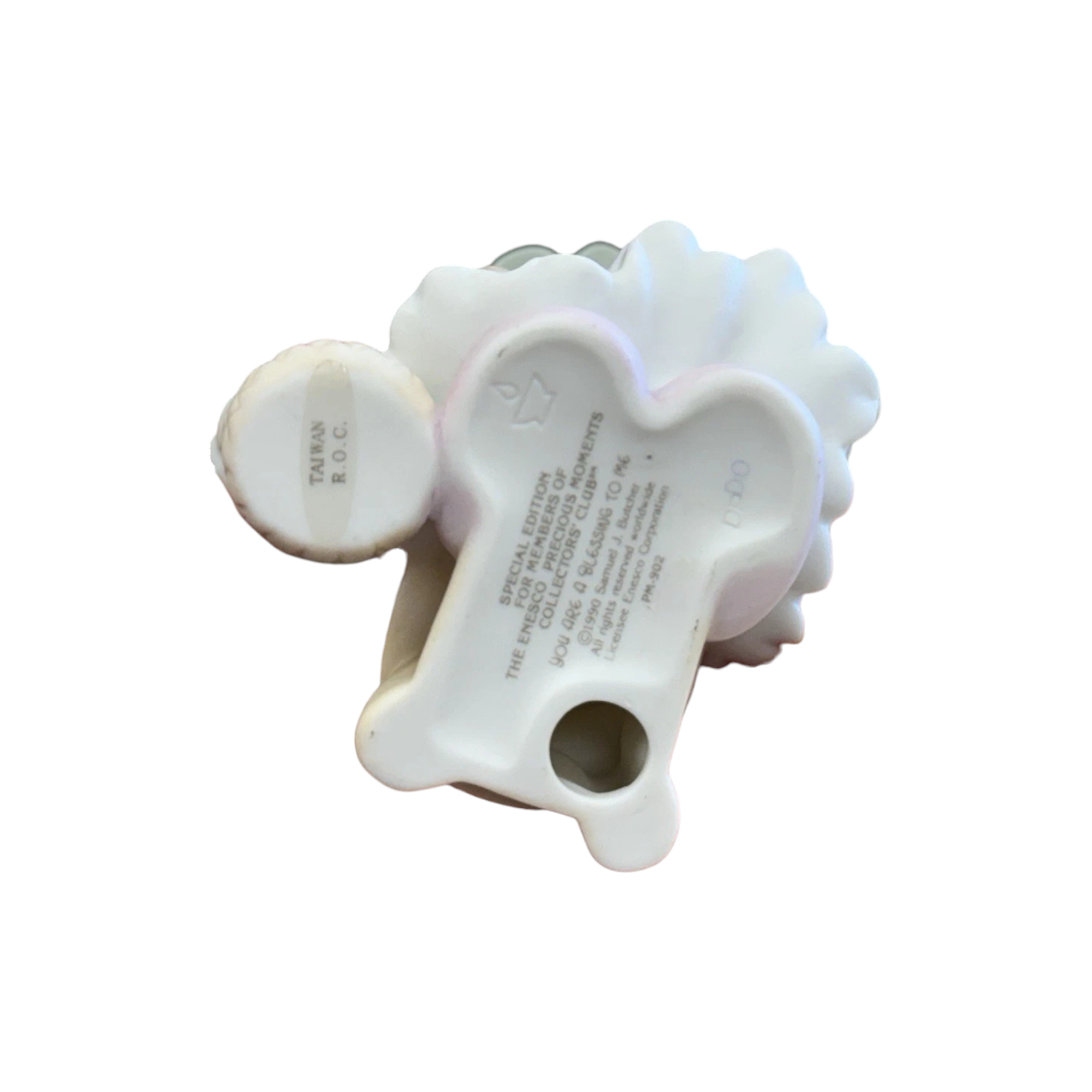 Adorable girl sews patch onto beloved teddy bear