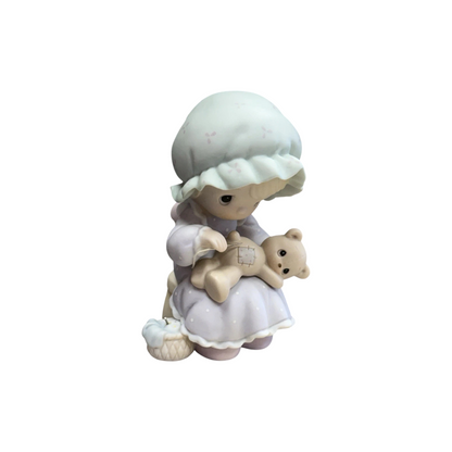 Adorable girl sews patch onto beloved teddy bear Image3