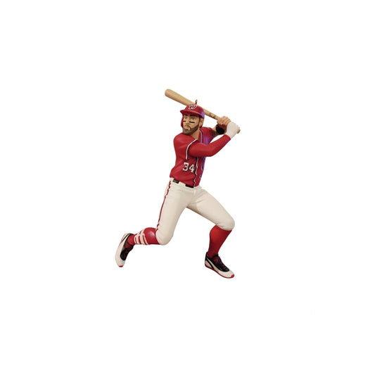 Baseball player figurine in red and white uniform with bat on a white background