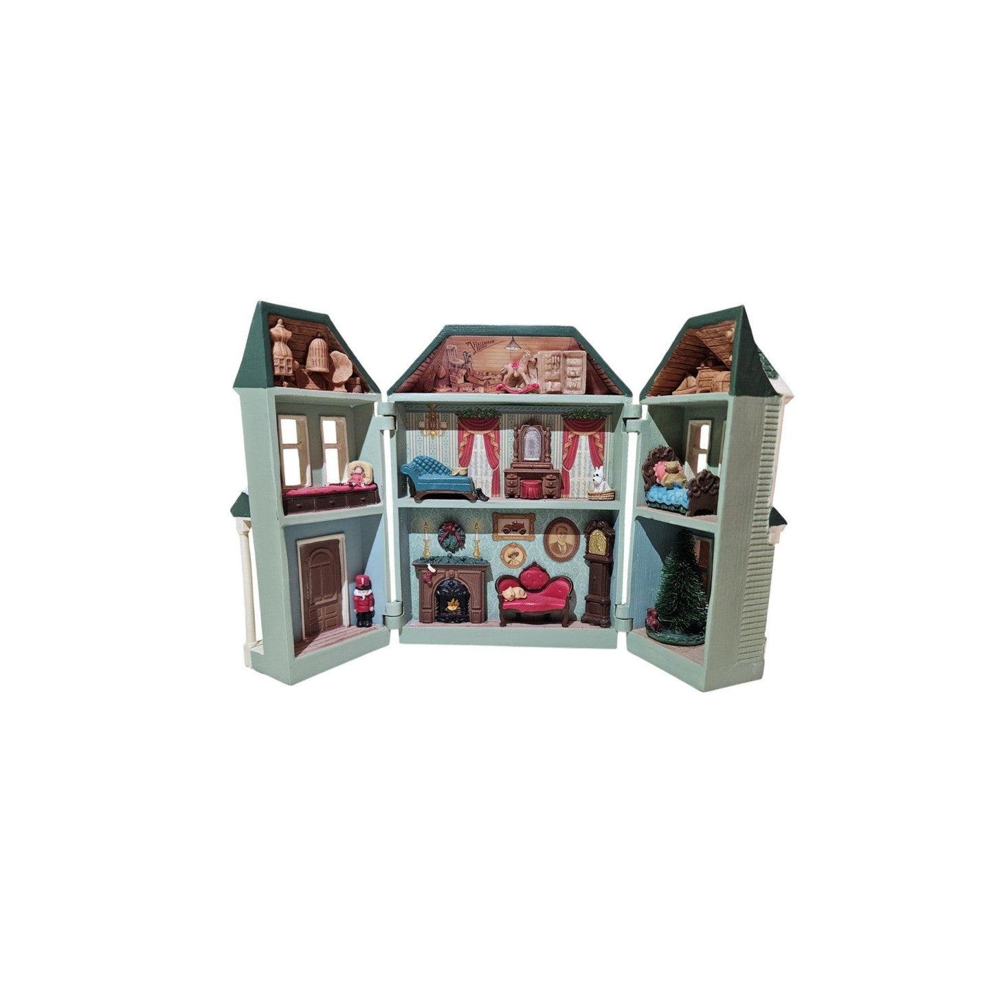 Toy dollhouse with open sections showing interior rooms and furniture on a white background