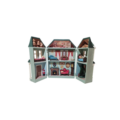 Toy dollhouse with open sections showing interior rooms and furniture on a white background