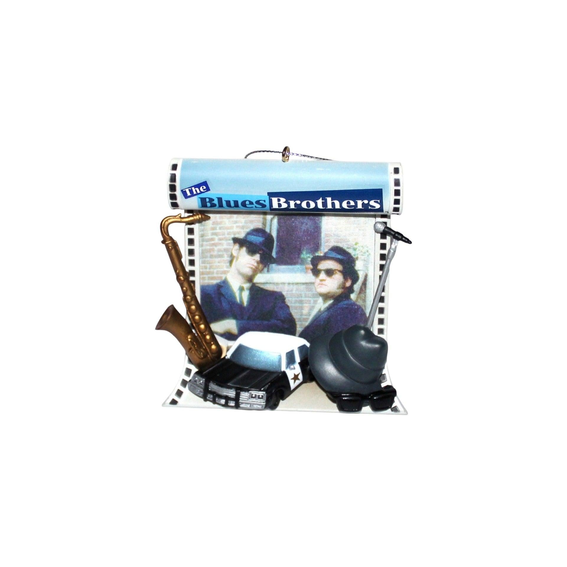 Decorative item with 'The Blues Brothers' design featuring two people and musical instruments on a white background.