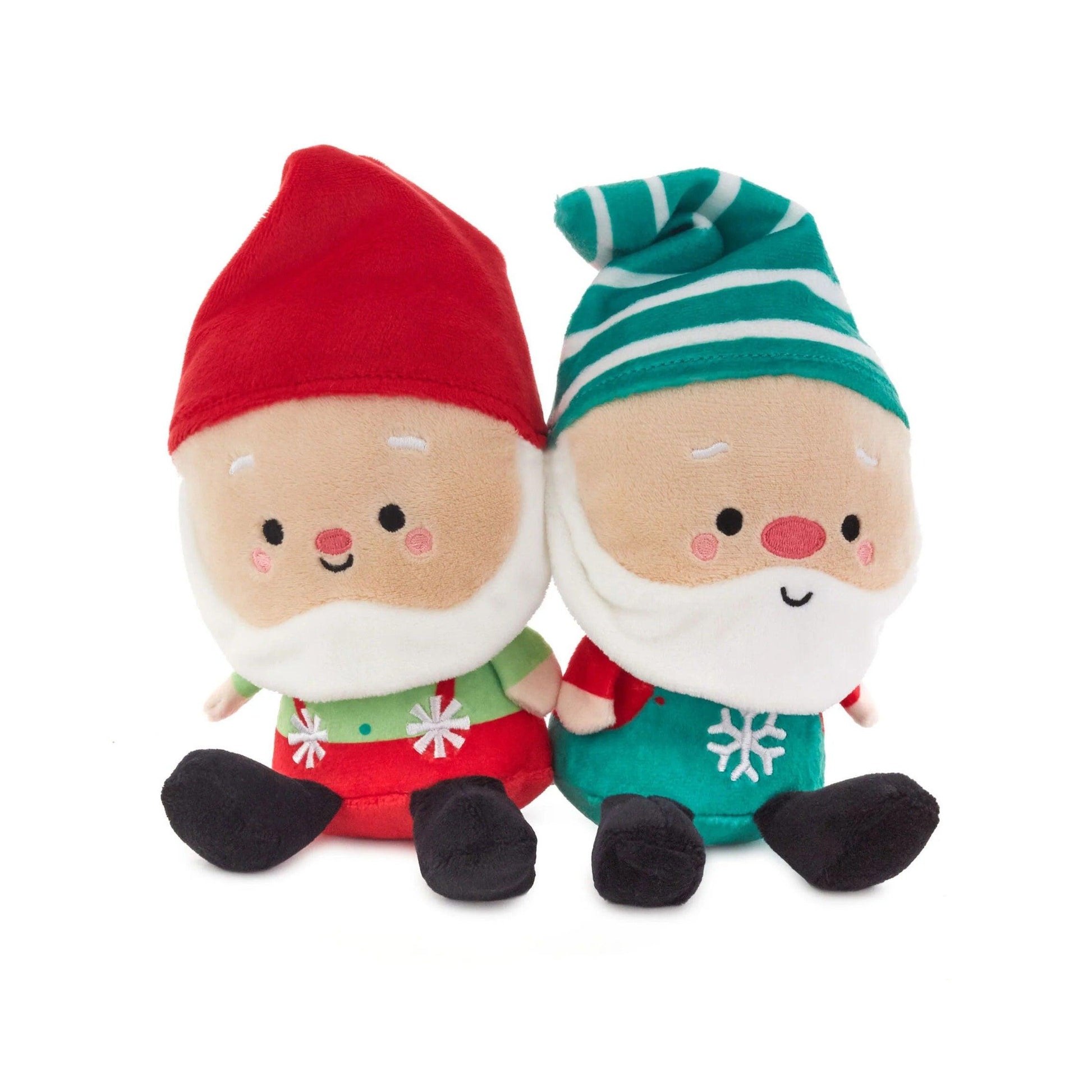 Two plush Christmas gnomes with red and green hats on a white background