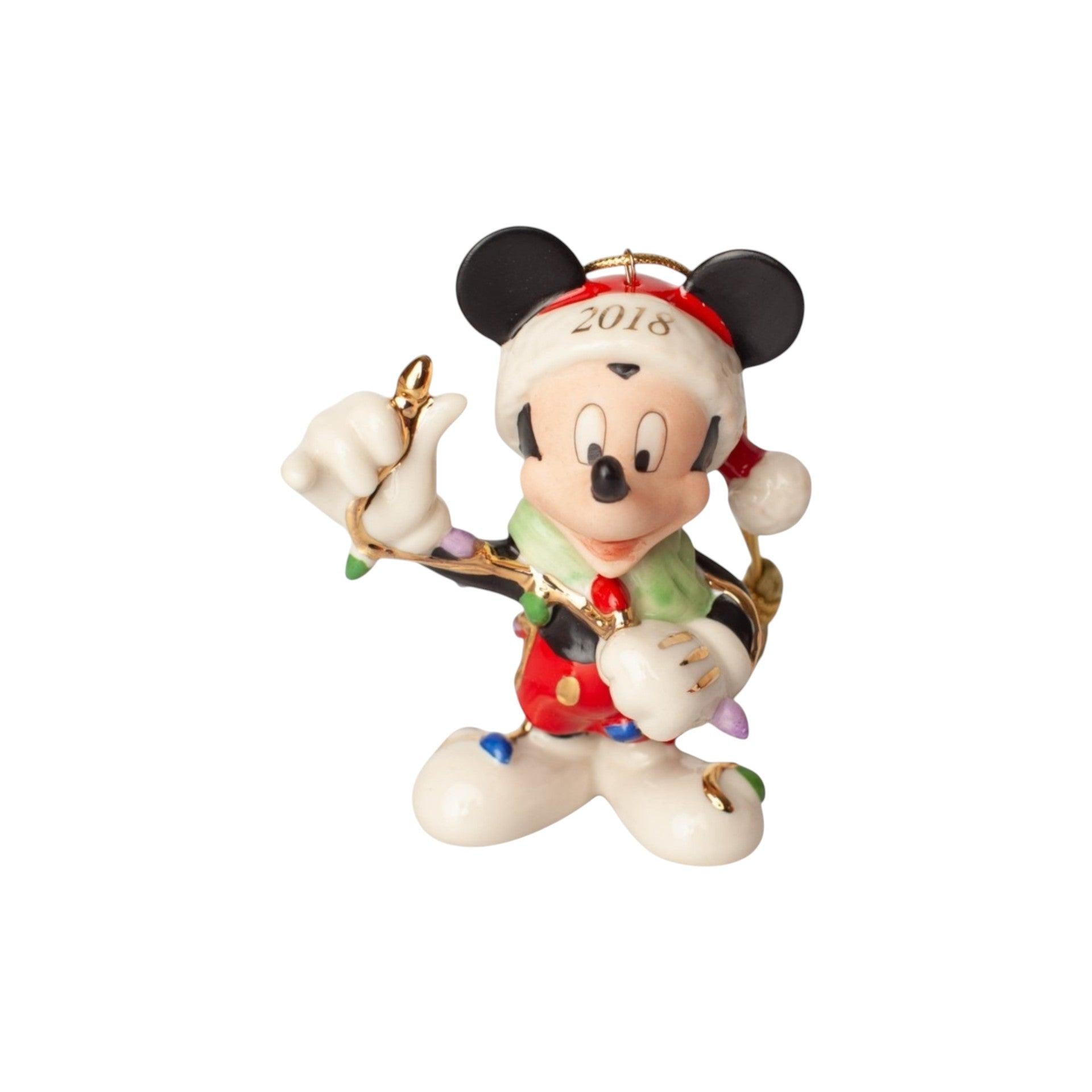Mickey Mouse ornament holding a bell with '2018' on a white background