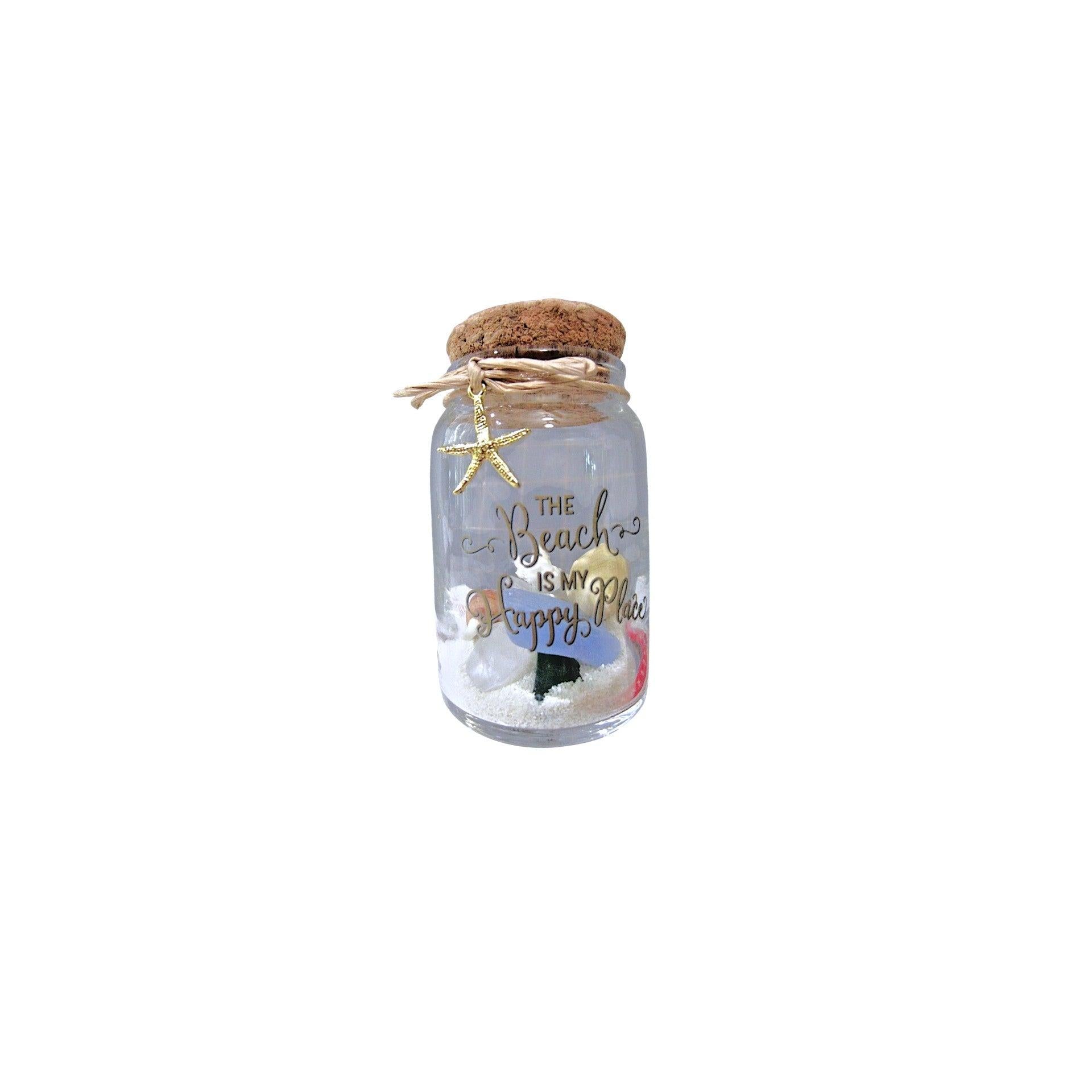 Decorative jar with cork lid, starfish, and sandcastle on a white background