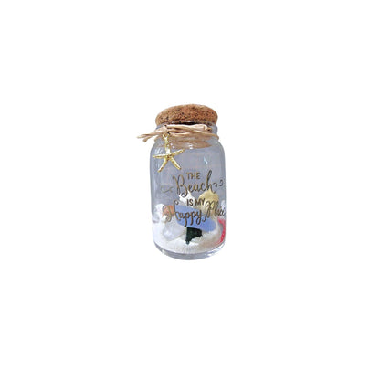 Decorative jar with cork lid, starfish, and sandcastle on a white background