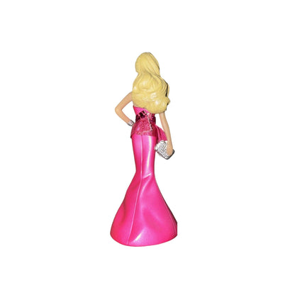 Figurine of a woman in a pink dress with a white background