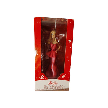 Barbie ornament in red dress packaging on a white background