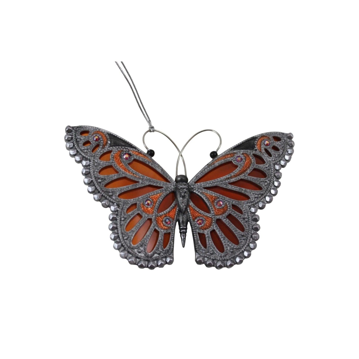Decorative butterfly ornament with intricate design on a white background
