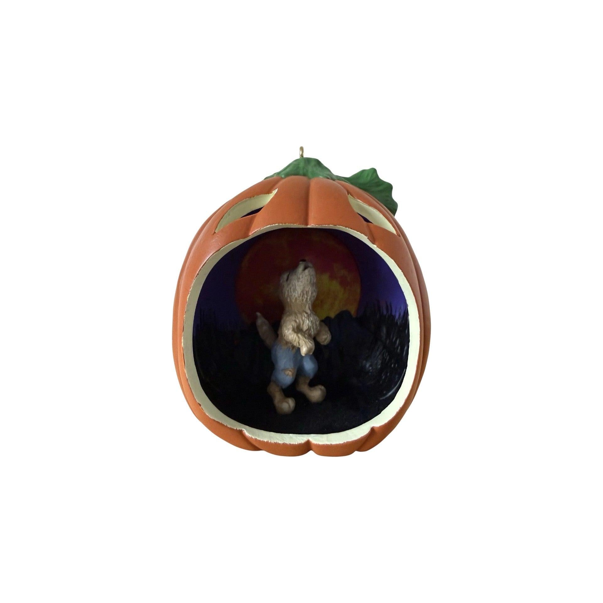 Pumpkin-shaped container with a small figurine inside on a white background
