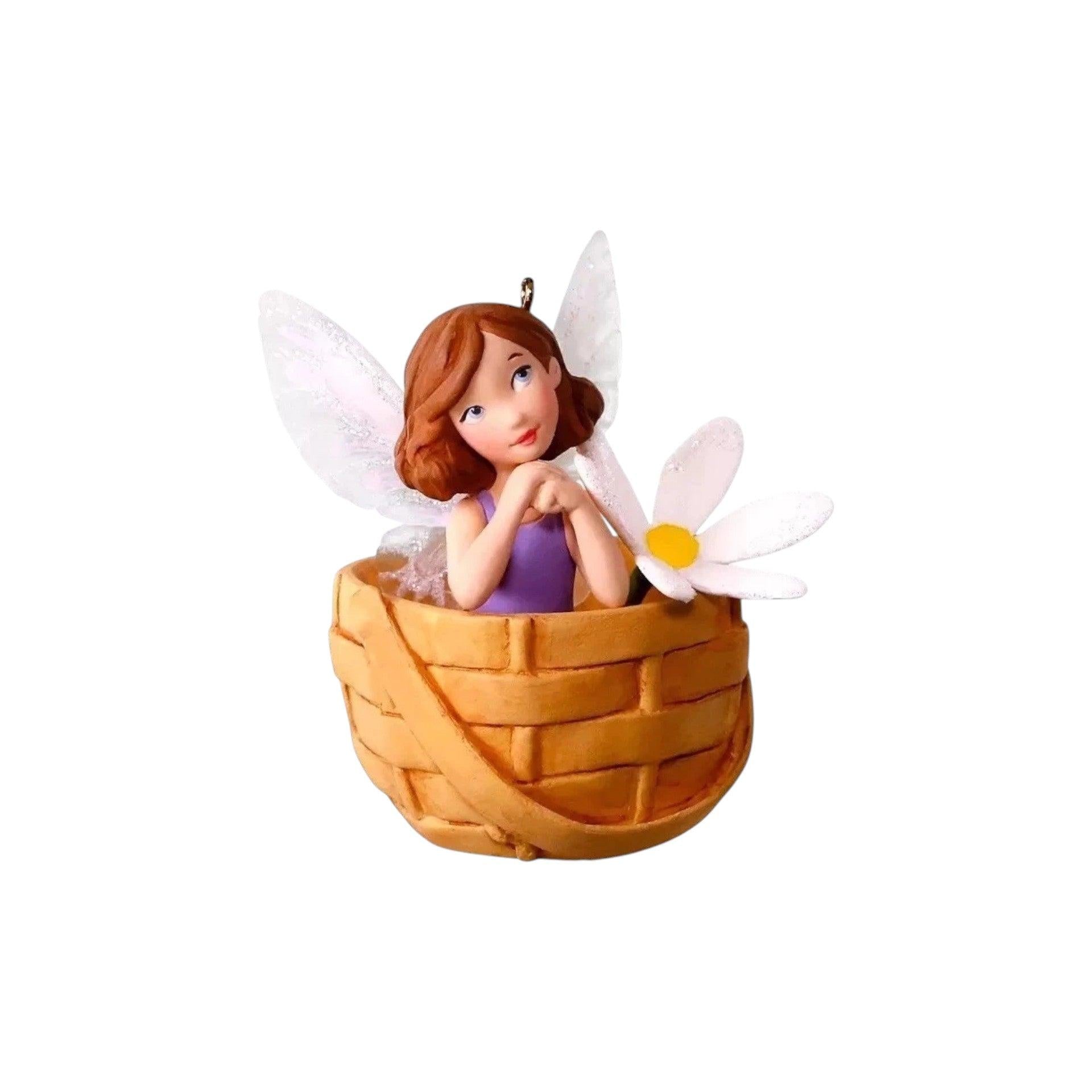 Fairy figurine with a basket and flower on a white background