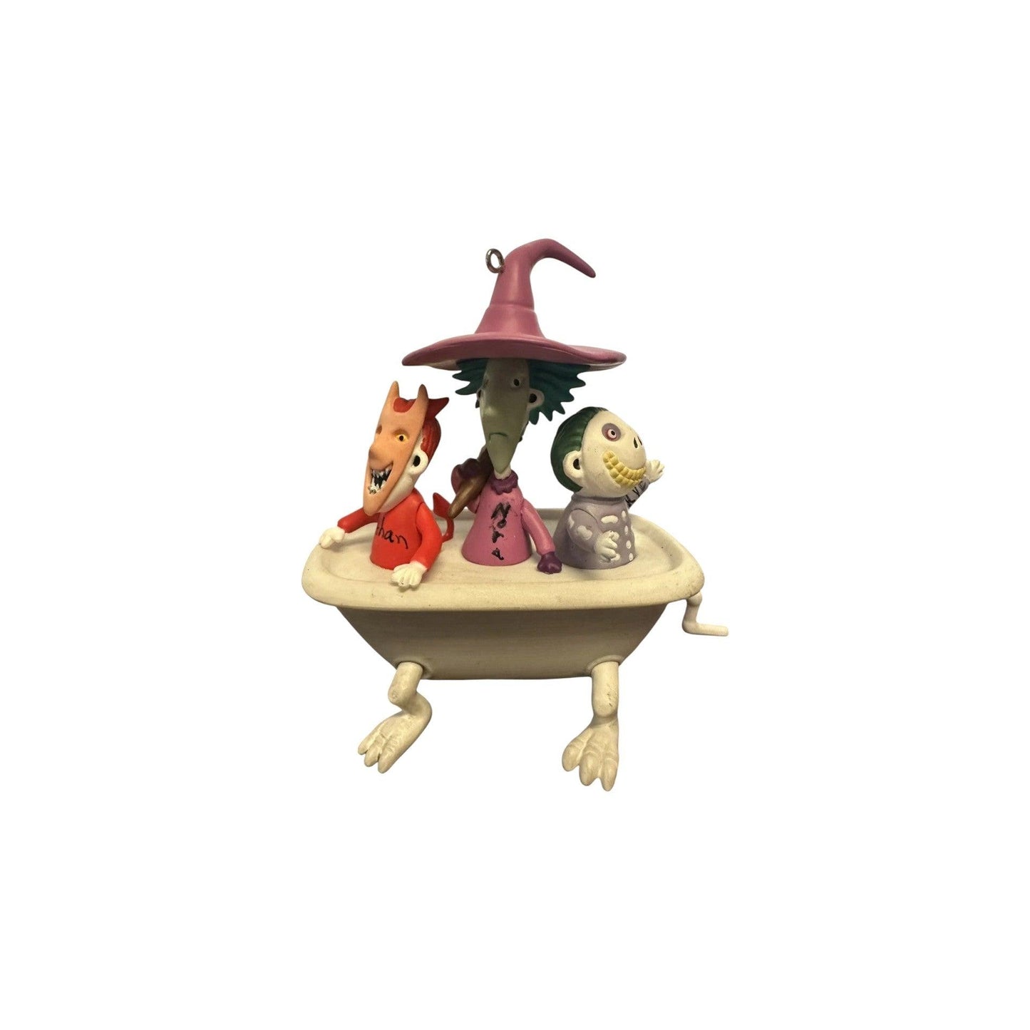 Three animated character figurines on a boat with a witch hat on a white background