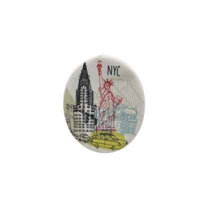 Button badge with illustrations of the Statue of Liberty, Chrysler Building, and yellow taxi on a white background.