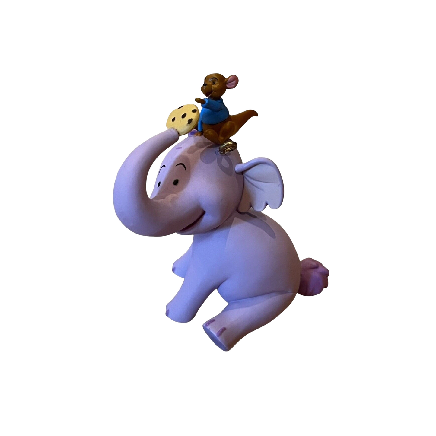 Toy figure of an elephant with a mouse on its head against a white background