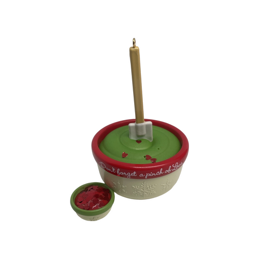 Decorative bowl with a spoon and small container on a white background