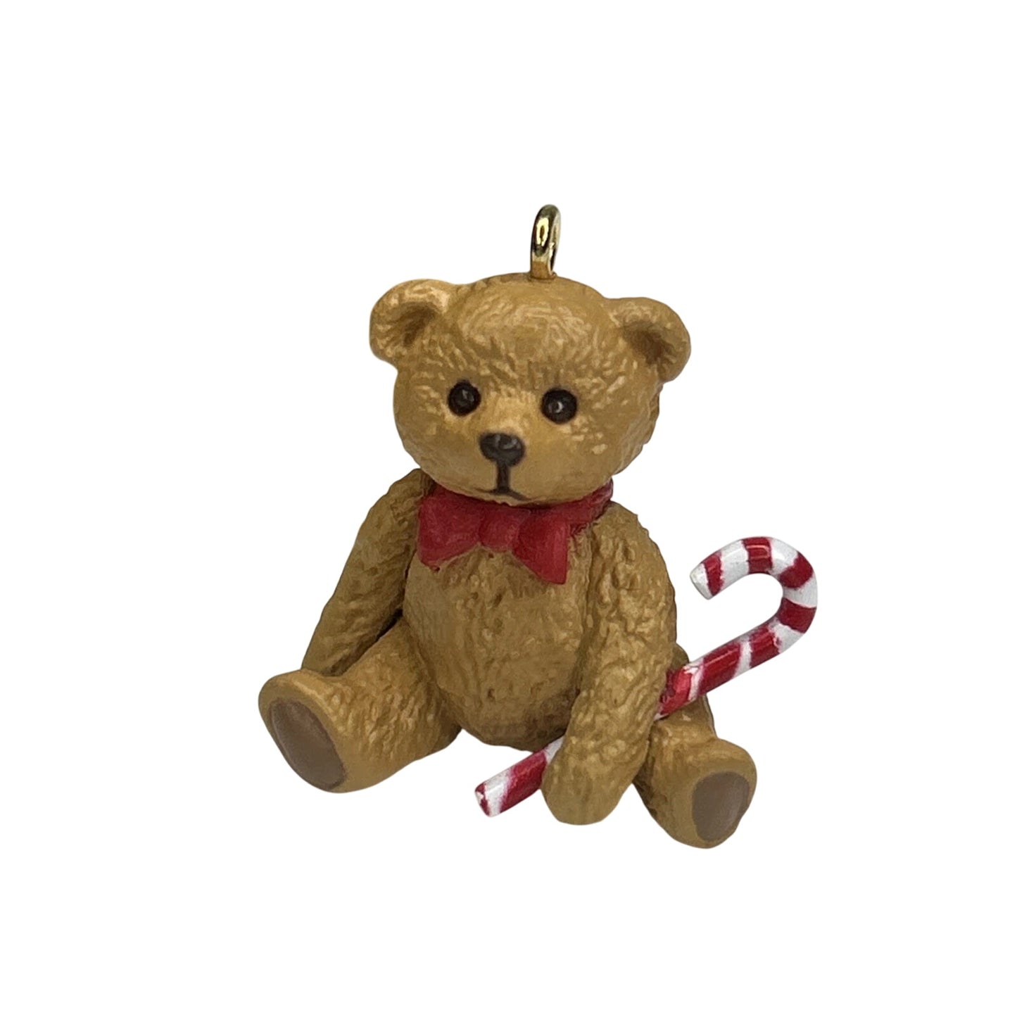 Teddy bear ornament with a candy cane on a white background