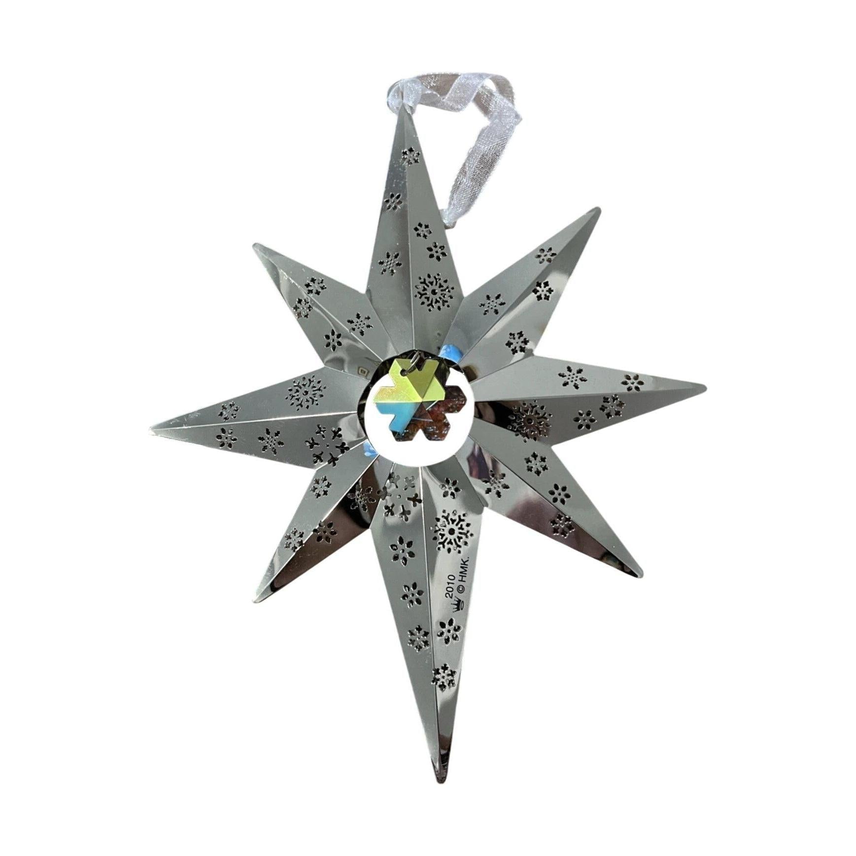 Decorative metal star with cut-out patterns on a white background