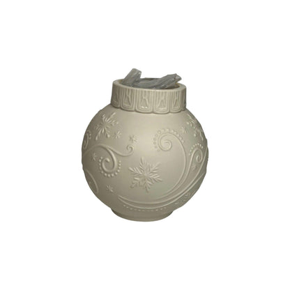 Decorative spherical lantern with snowflake patterns on a white background