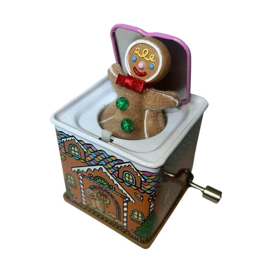 Gingerbread man music box with a hand crank on a white background