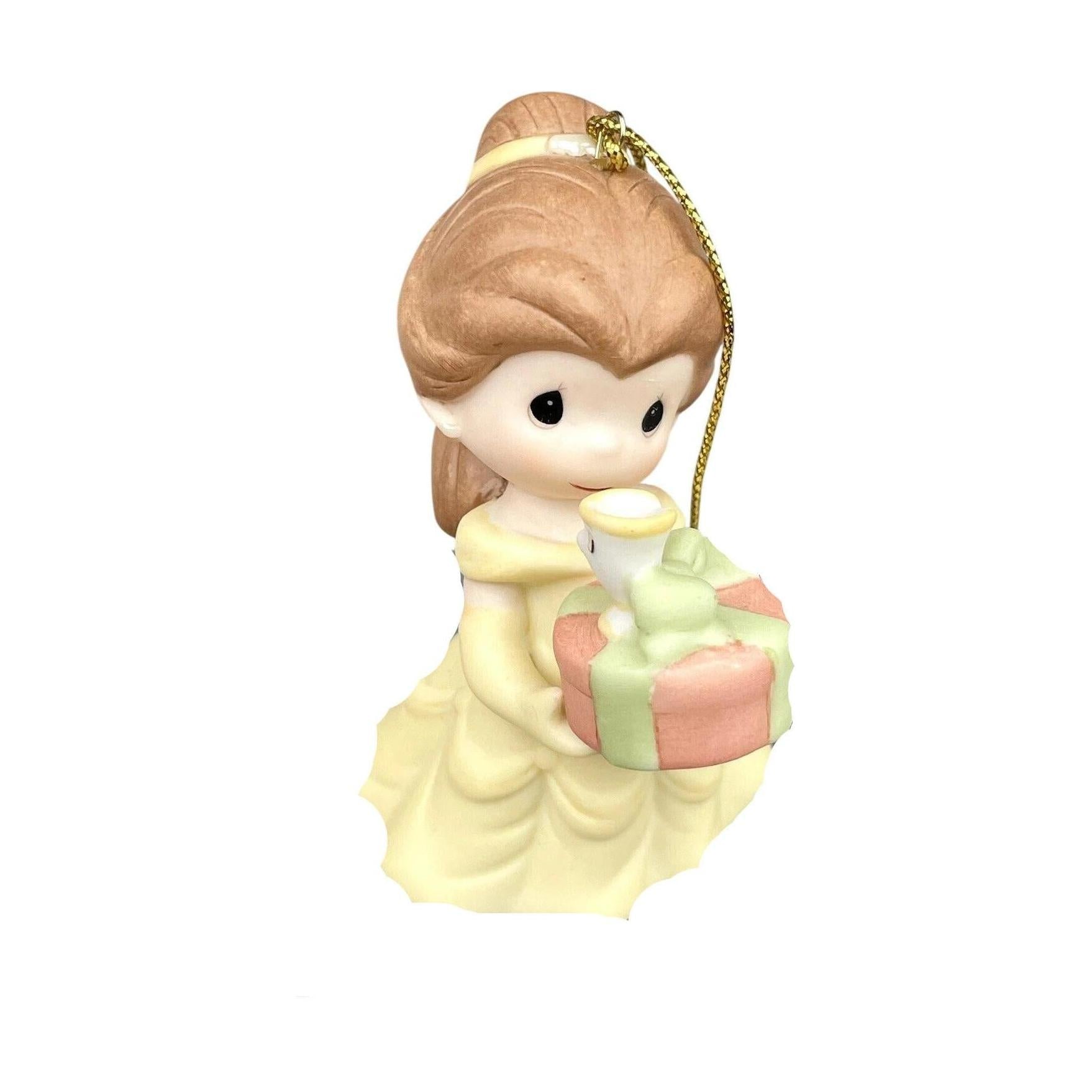 Small figurine of a girl holding a gift box on a white background