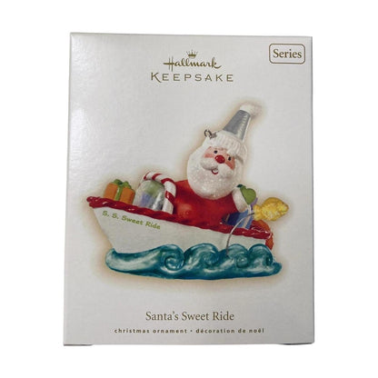 Hallmark Keepsake Christmas ornament packaging with Santa Claus in a boat on a white background