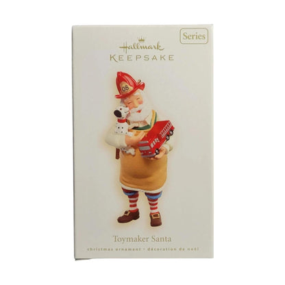 Hallmark Keepsake ornament packaging featuring a Santa figure with a dog and toy truck.