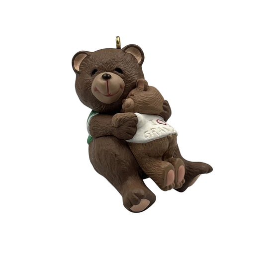 Decorative bear ornament holding a baby bear with 'Grandpa' on its shirt against a white background