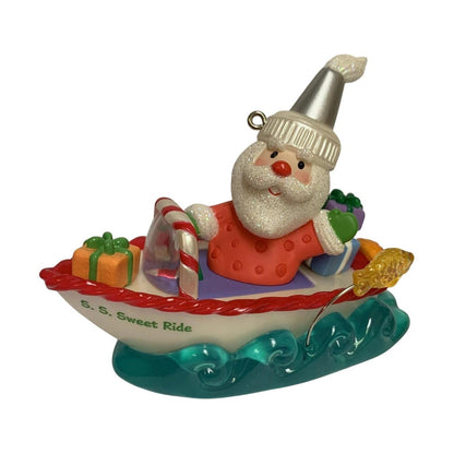 Santa Claus on a boat ornament with candy cane details on a white background