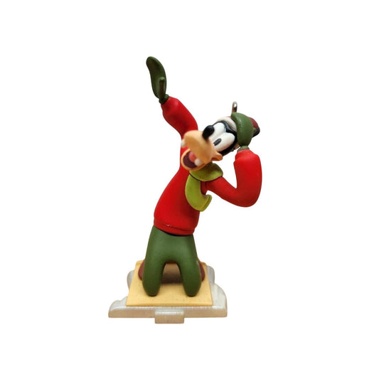 Animated character figurine in red sweater and green hat on a white background